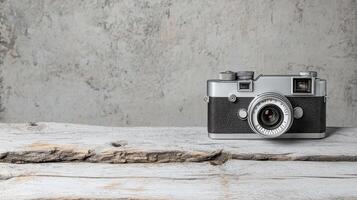 An old camera sitting on a wooden table photo