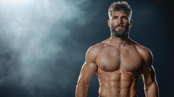 A man with no shirt on standing in front of a dark background photo