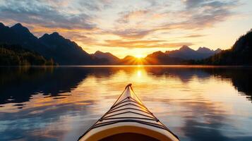 A canoe is in the water at sunset photo