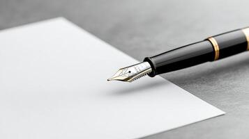 A fountain pen is writing on a piece of paper photo