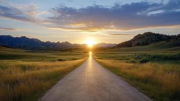scenic sunset view over road surrounded by mountains and grasslands photo