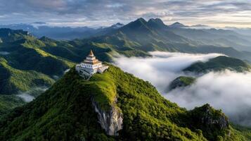 serene mountaintop monastery surrounded by lush green mountains and mist photo