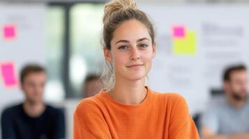 confident woman in orange sweater smiles in modern office setting photo