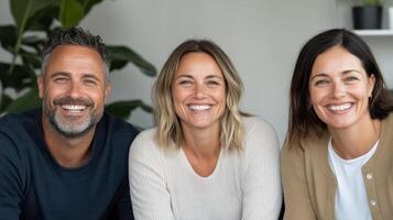 Happy group of three adults smiling together in modern setting photo