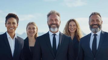 Professional business team smiling outdoors with mountains in background photo