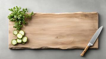 Fresh herbs and sliced cucumbers on wooden cutting board create vibrant kitchen scene photo