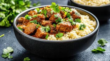 delicious bowl of Moroccan lamb stew served over fluffy couscous, garnished with fresh herbs photo