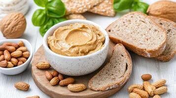 Creamy nut butter served with whole grain bread and nuts creates healthy snack scene photo