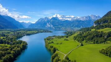 Breathtaking landscape featuring mountains, river, and lush greenery in Swiss Alps photo