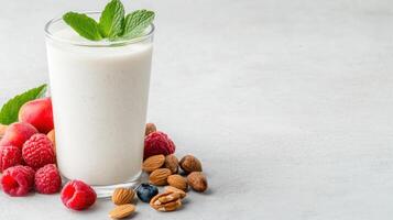 refreshing glass of homemade yogurt drink garnished with mint, surrounded by fresh fruits and photo