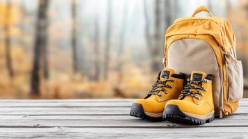 Stylish hiking boots and backpack on wooden surface, perfect for outdoor adventures photo
