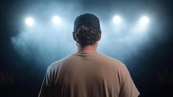 performer stands confidently stage, illuminated by bright lights, ready to share their passion photo