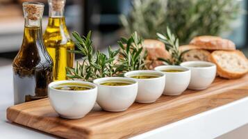 Fresh olive oil tasting event with small cups, bread, and herbs photo
