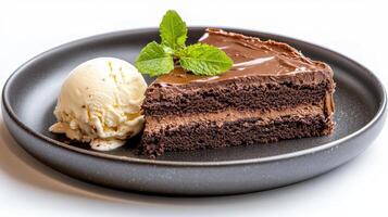 delicious slice of double chocolate cake served with creamy vanilla ice cream and fresh mint photo
