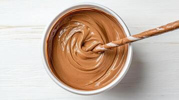 Creamy chocolate mixture in bowl with swirled texture, perfect for desserts photo