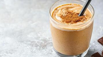 Creamy protein shake topped with cocoa powder, served glass with straw, exuding deliciousness photo