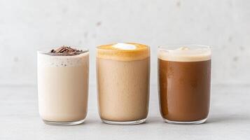 Creamy iced drinks in clear glasses, showcasing variety of textures and flavors photo