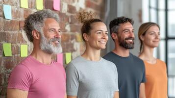 Smiling group of diverse individuals standing in line, showcasing teamwork and positivity photo