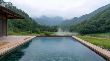 serene traditional Japanese onsen with tranquil pool reflecting surrounding mountains and mist photo