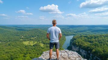 traveler standing at scenic overlook, admiring vast landscape and feeling inspired photo