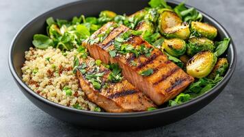 Grilled salmon with quinoa and Brussels sprouts creates healthy, vibrant meal photo