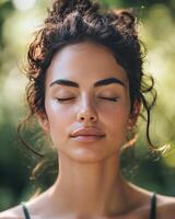 Young woman practicing mindfulness in a serene outdoor setting surrounded by nature photo