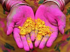 Colorful celebration of Holi with vibrant powders in hands photo