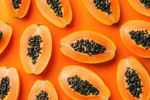 Freshly sliced papaya arranged on an orange background photo