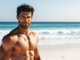 Muscular man enjoys sunny day at beach with waves rolling in photo