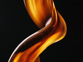 Golden fluid sculpture swirling against a dark background photo