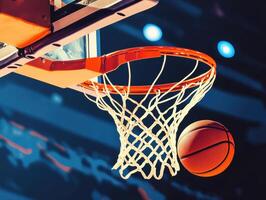 Basketball approaches the hoop in an indoor arena during evening game photo