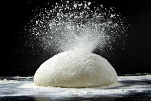 Flour erupts from kneaded dough during bread preparation process photo
