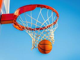 Basketball hoop with a ball nearing the net in clear sky photo