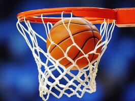 Basketball successfully scores in the hoop during a game photo