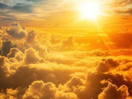 Sunset over clouds with golden hues illuminating the sky photo