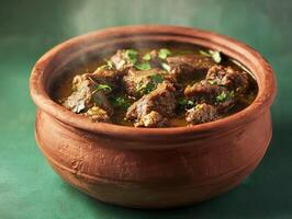 Delicious stew served in a traditional clay pot on a textured surface photo