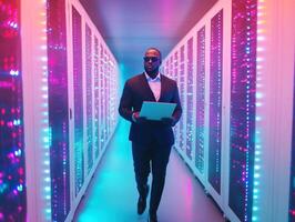Business professional walks through vibrant data center hallway photo
