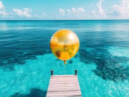 Golden balloon floats above turquoise water on a sunny day photo