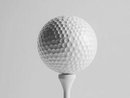 Golf ball on a tee against a neutral background photo