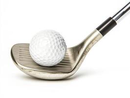 Golf club resting on a tee with a white golf ball ready to swing photo