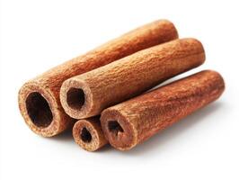 Cinnamon sticks arranged on a plain surface ready for cooking photo