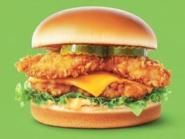 Delicious crispy chicken sandwich with pickles and cheese photo