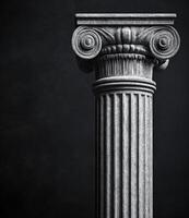 Elegant stone column against dark background with intricate design photo