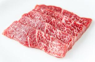 Delicious marbled beef slices ready for grilling or cooking photo