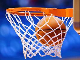 Basketball scores as ball swishes through net in a game photo