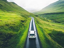 Driving along a scenic road in a lush green valley landscape photo