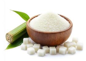 Sugar in a wooden bowl with sugarcane and cubes on a white background photo