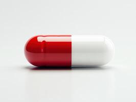Red and white capsule on a clean surface ready for use photo