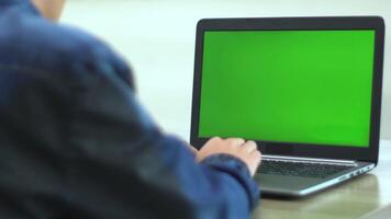 Man hands writing on green screen laptop sitting office close up. Unknown businessman typing document searching information surfing internet using mockup computer. Manager working on chroma key pc. video