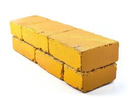 Bright yellow building bricks arranged in a stack for construction photo
